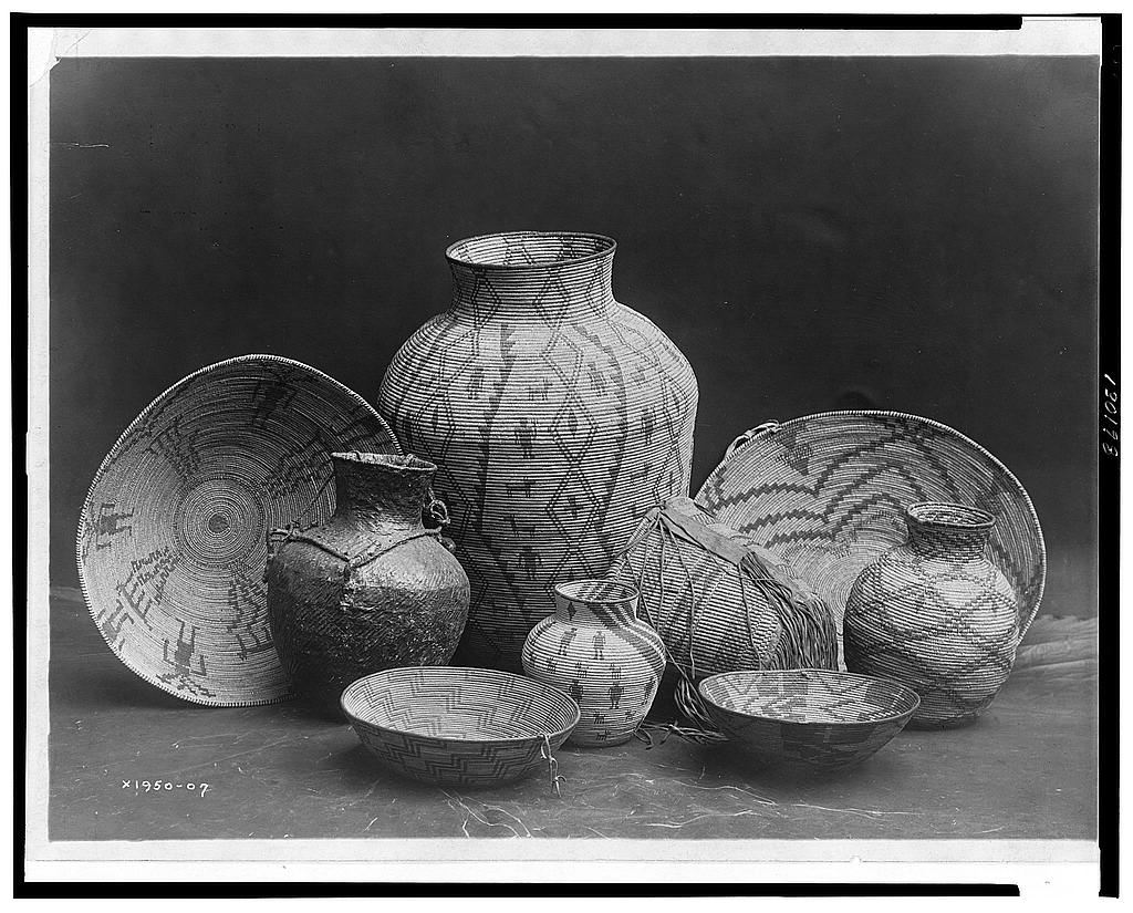 Edward Curtis photograph of nine baskets, bowls and jars arranged as an Apache still life
