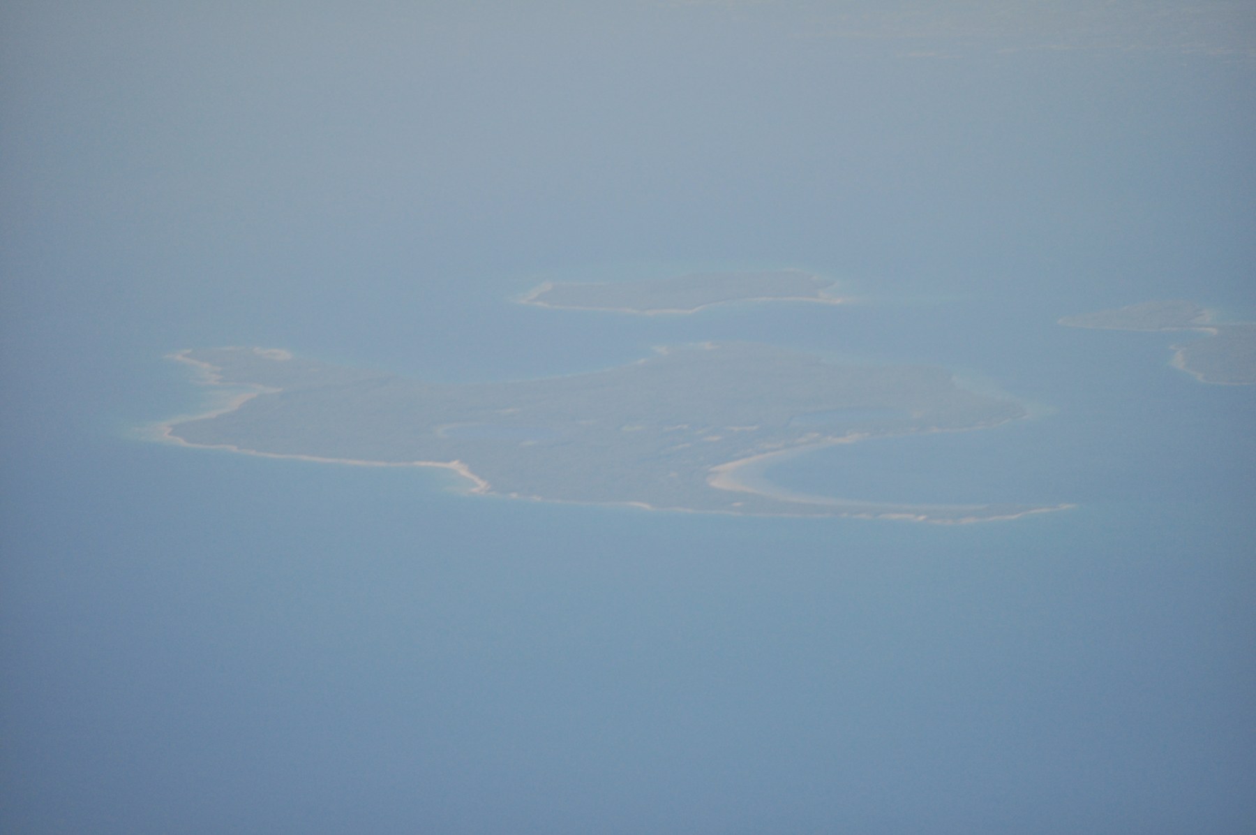 Hazy aerial view of Christian Island in Georgian Bay, surrounded by blue water.