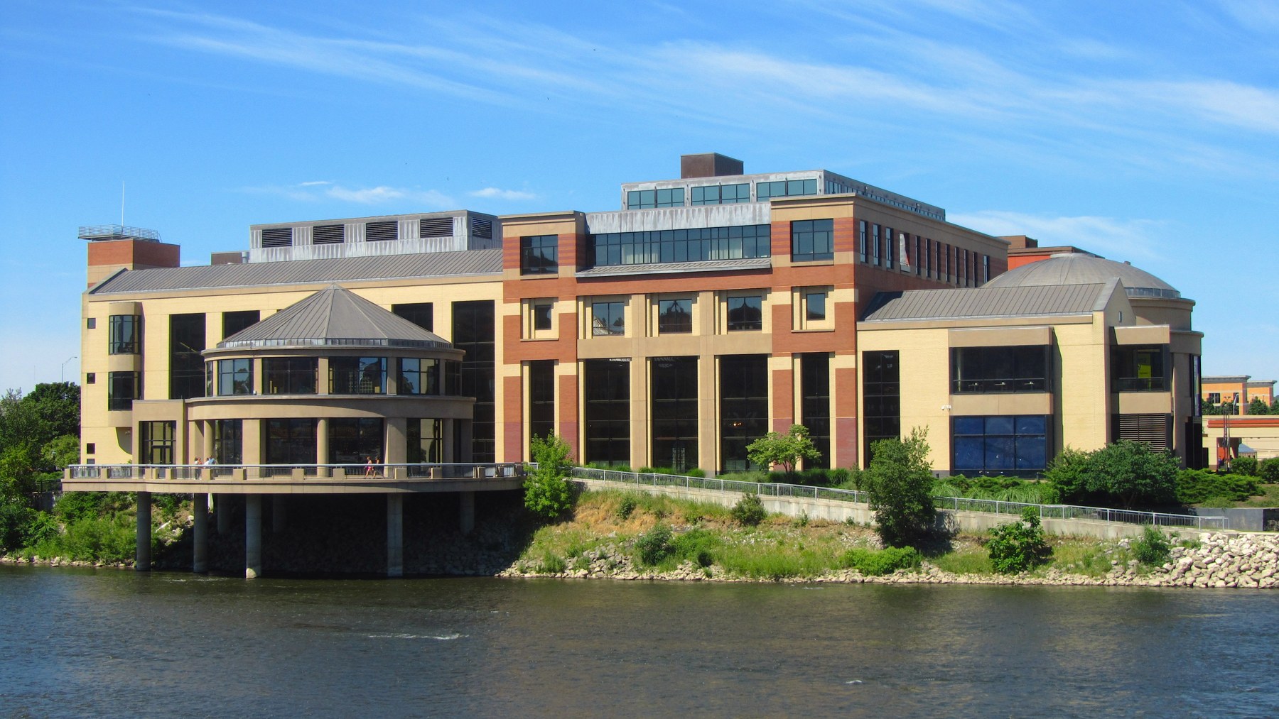 The exterior of the Grand Rapids Public Museum beside the river.