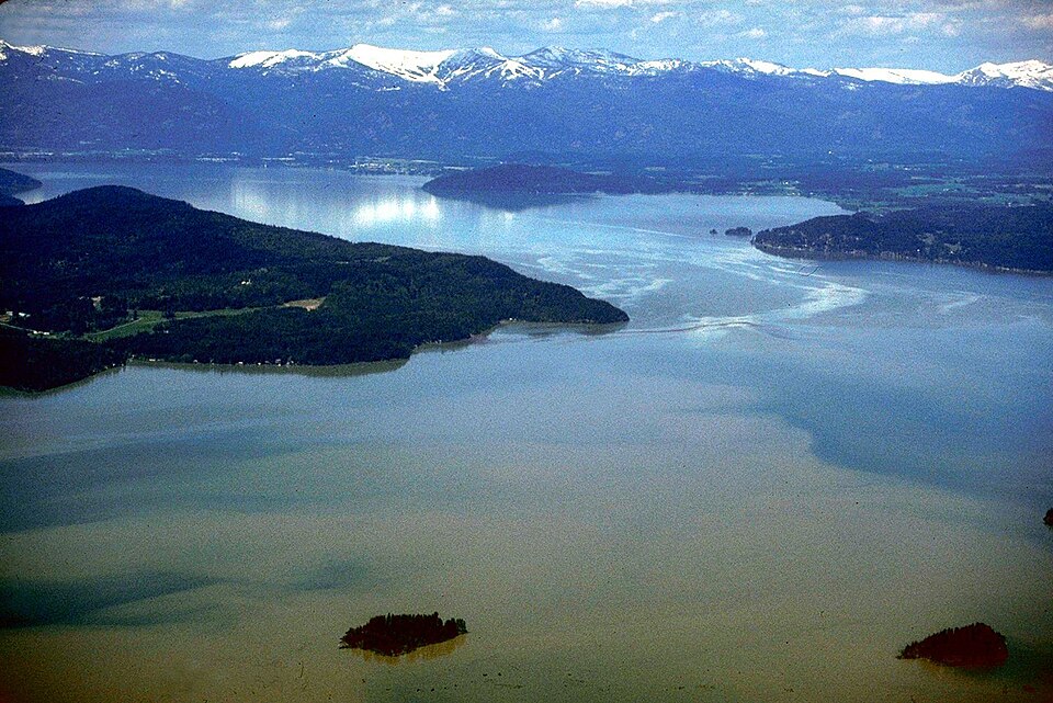 Aerial view of Lake Pend Oreille with forested slopes and shoreline in Idaho.