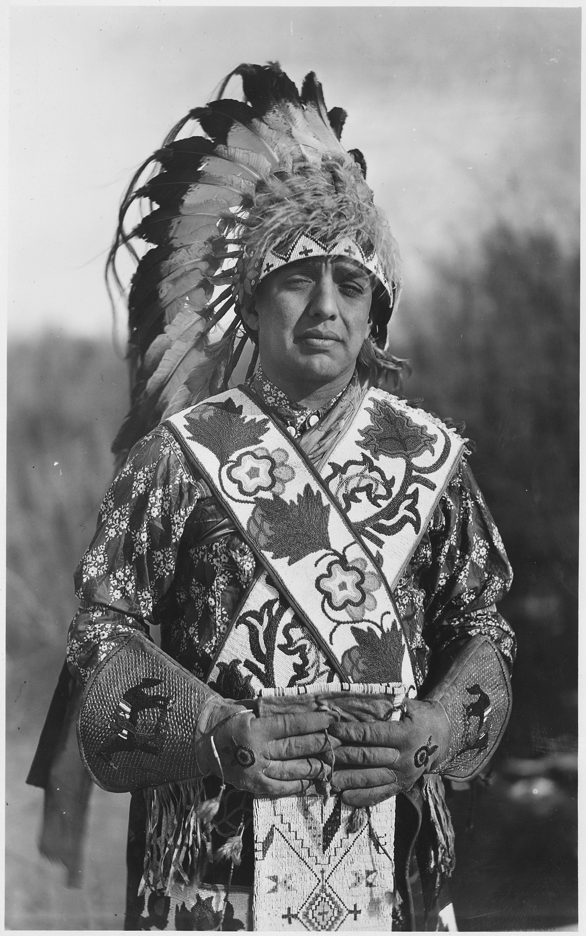 Black-and-white portrait of George P. LaVatta in regalia, with his hands together at his waist.