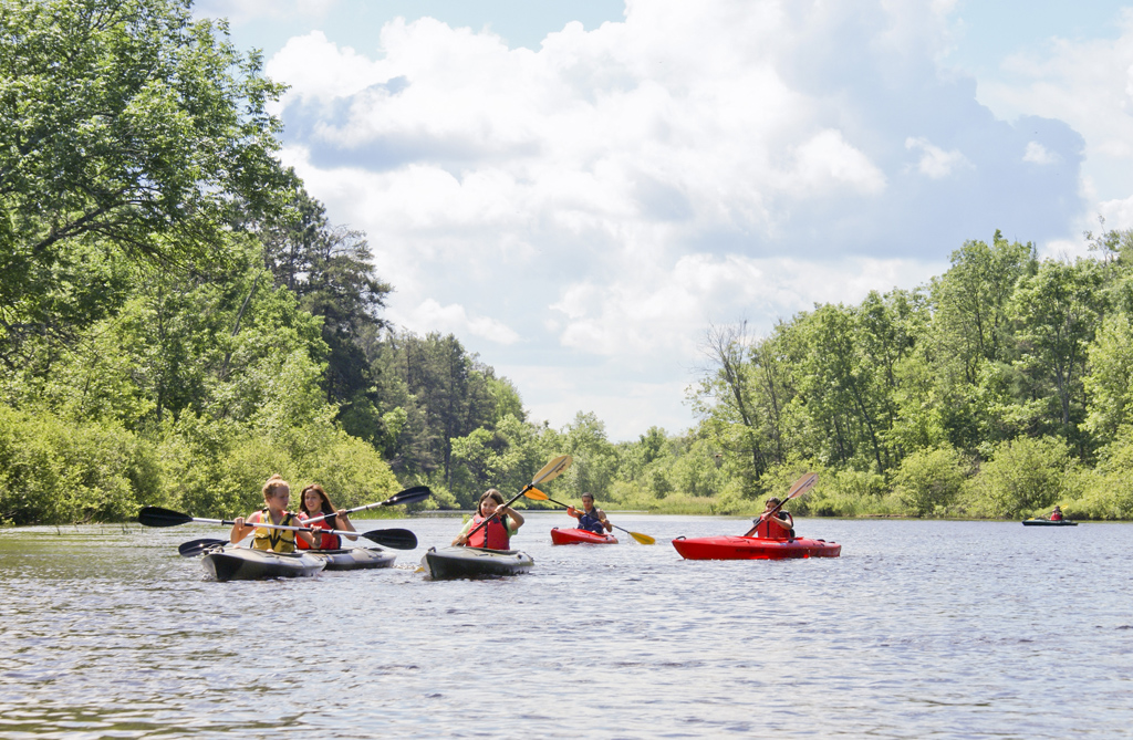 Lac Courte Oreilles Boys and Girls Club paddlers kayak on the Namekagon River during a June 2014 outing.