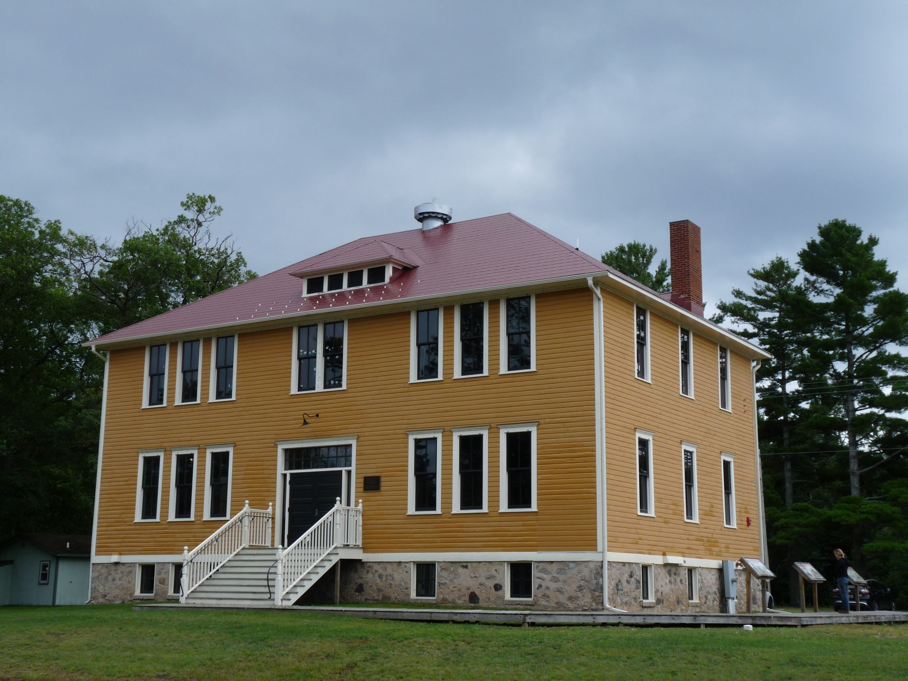 The yellow former boys dormitory of the government boarding school at Lac du Flambeau, photographed in 2019.