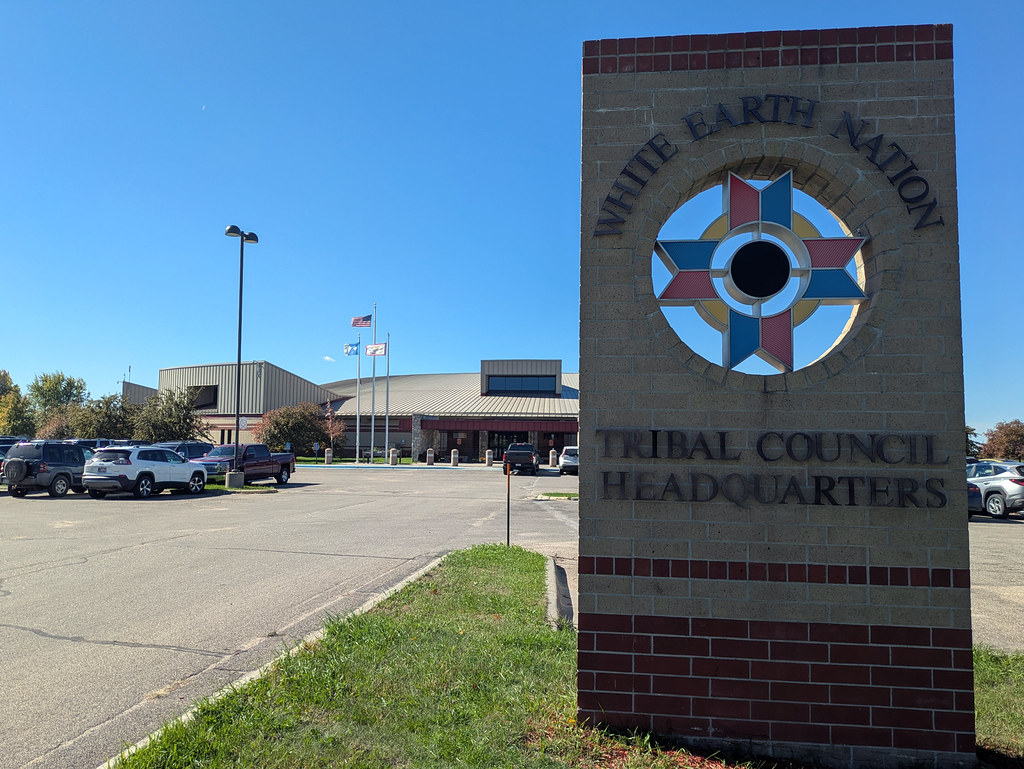The White Earth Nation Tribal Council Headquarters building and a large identifying sign beside its parking area.